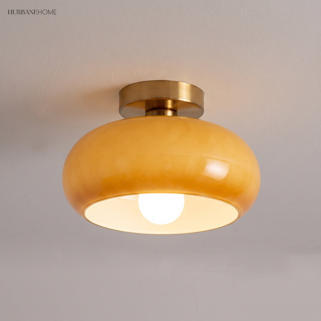 Amber glass semi flush mount light set close to a plaster ceiling