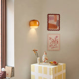 Amber glass sconce lighting a cosy corner near a reading chair