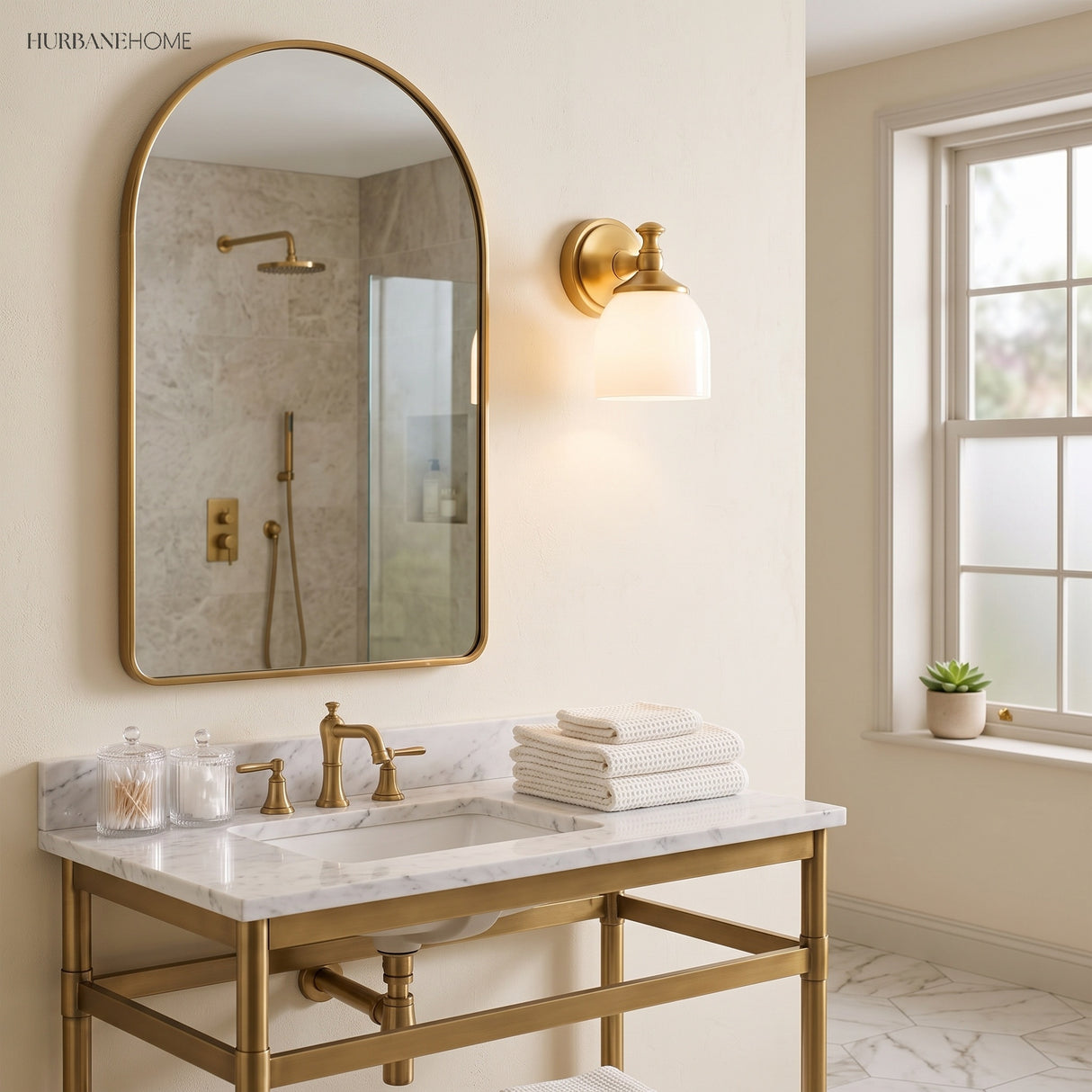 Milk glass sconce beside an arched mirror over a marble bathroom vanity