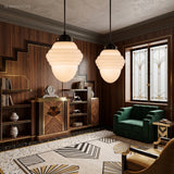 Two stepped milk glass pendants in a walnut panelled art deco lounge