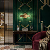 Moth wall sconce on emerald panelling above a slim console and bar