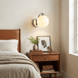 Art Deco opal glass globe wall sconce with a curved metal arm, view 7