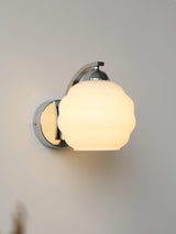 Art Deco opal glass globe wall sconce with a curved metal arm, view 31