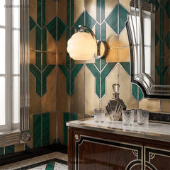 Chrome and opal glass sconce on green and gold geometric tiled wall