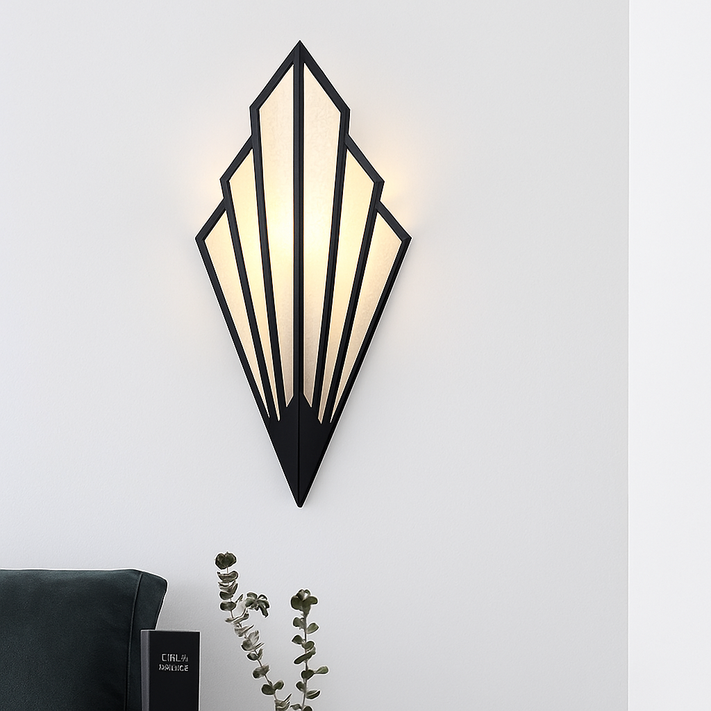 Black fan sconce lit on a white wall above a dark sofa