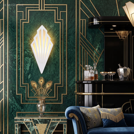 White fan sconce lit on a green marble wall in a bar room