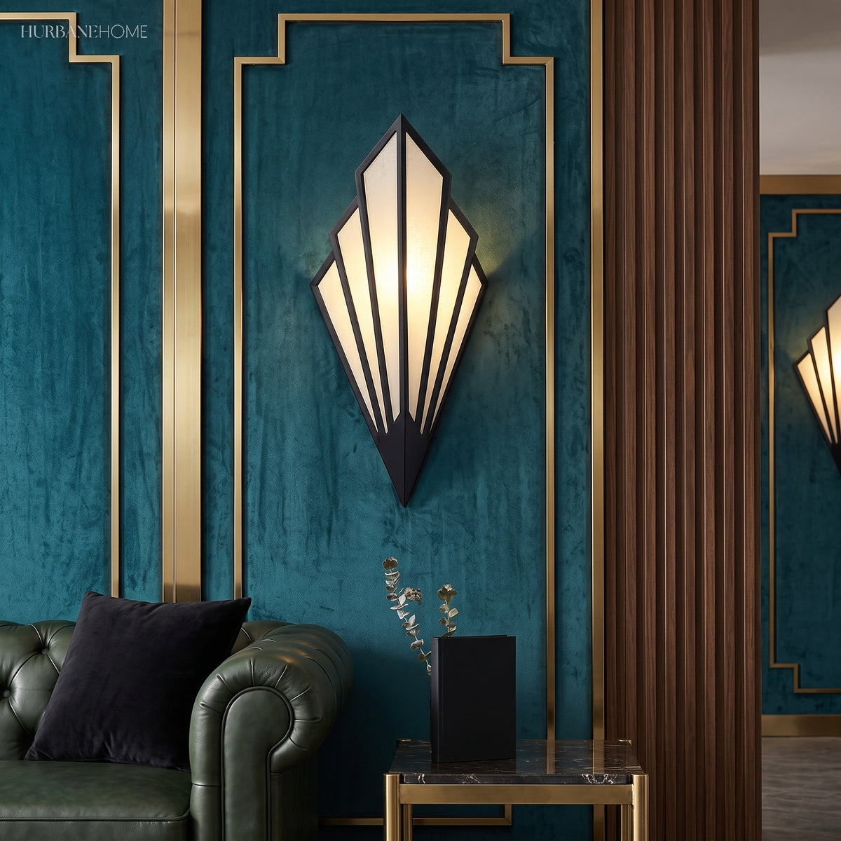 White fan sconce lit on a deep teal panelled wall above a sofa