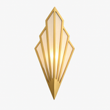 Gold fan sconce lit and shown against a plain light background