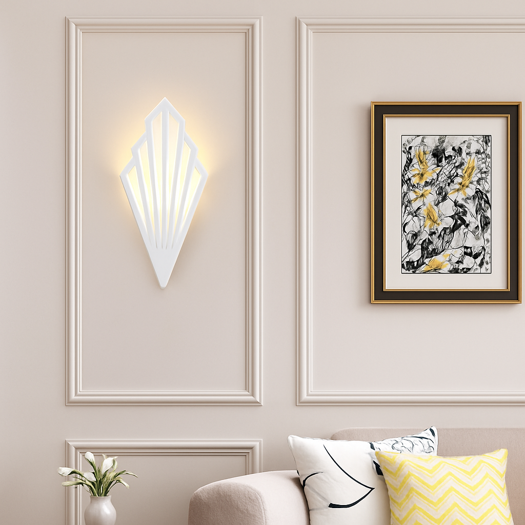 White fan sconce lit on a panelled wall beside framed art
