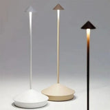 Waterproof cordless table lamp standing on an outdoor garden table