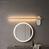 Slim wood vanity light above a round mirror with a lit rim