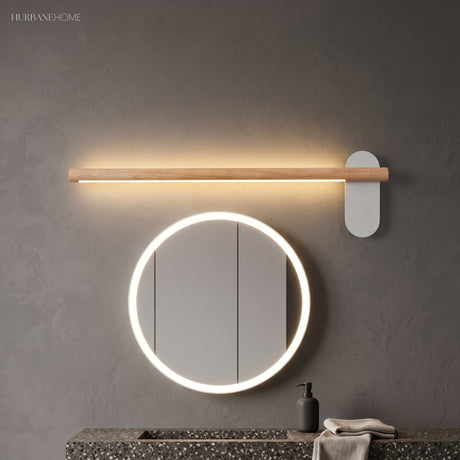 Slim wood vanity light above a round mirror with a lit rim