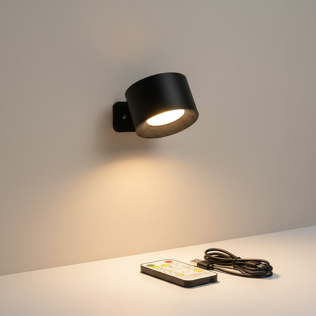 Black cordless sconce lit above a shelf beside a remote and cable