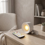 White rotating light on a pale desk beside its remote control