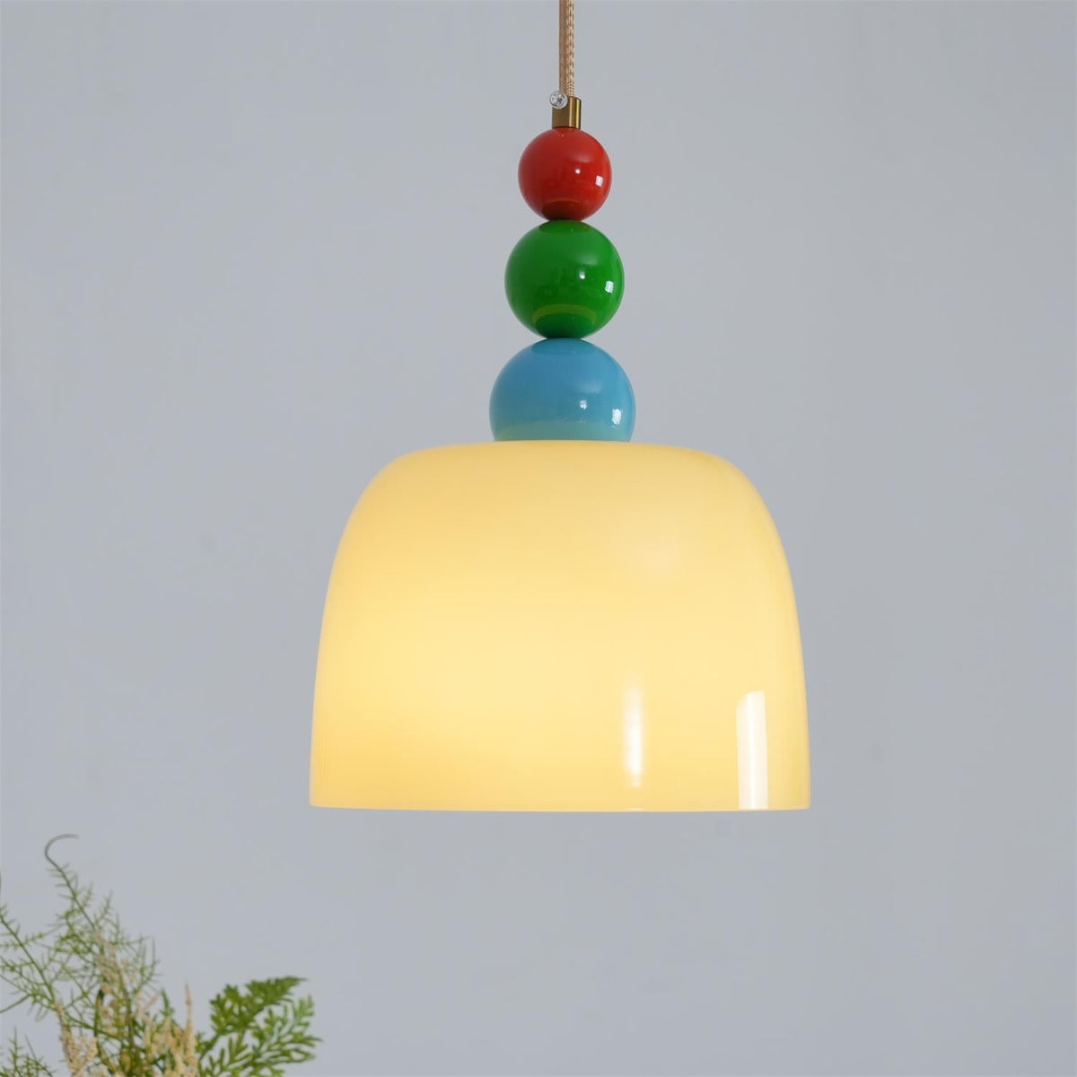 Detail of the red, green and blue beads sitting above the glass dome shade