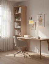 Beaded pendant lighting a home office desk beside a tall oak bookcase
