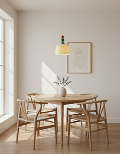 Beaded pendant above a round dining table with pale wishbone style chairs