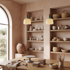 Two beaded glass pendants above a shelved dining room with an arched window