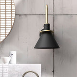 Black cone sconce beside a round mirror on a concrete bathroom wall