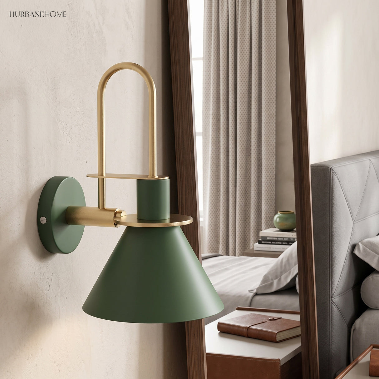 Green cone wall sconce beside a bedroom mirror and made bed