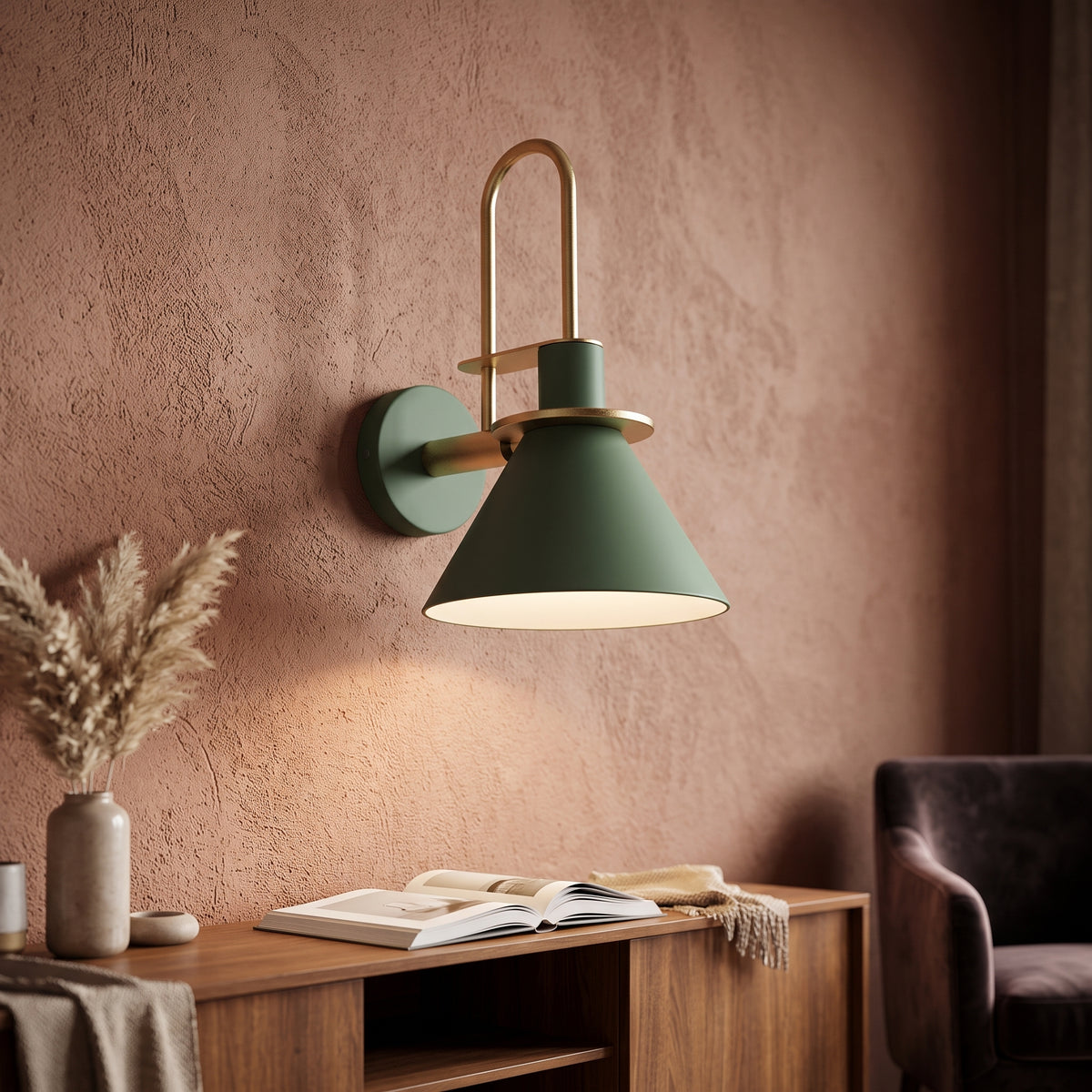 Green cone wall sconce lit above a timber desk on a clay wall