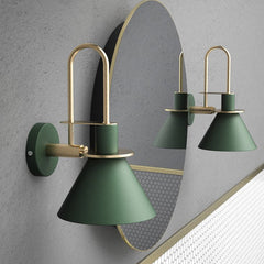 Two green cone sconces flanking a large round mirror on grey
