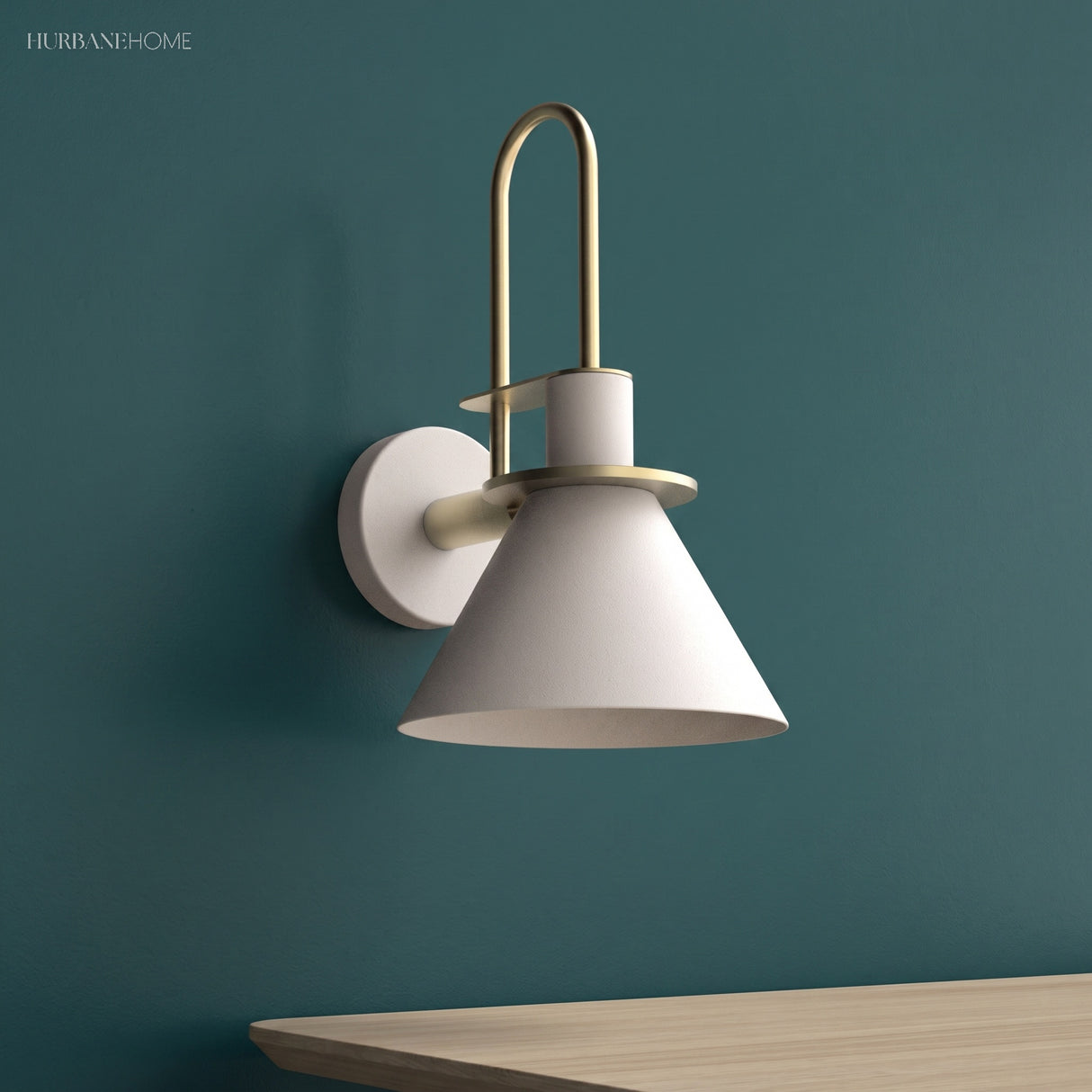 White cone wall sconce on a deep teal wall above a wood desk