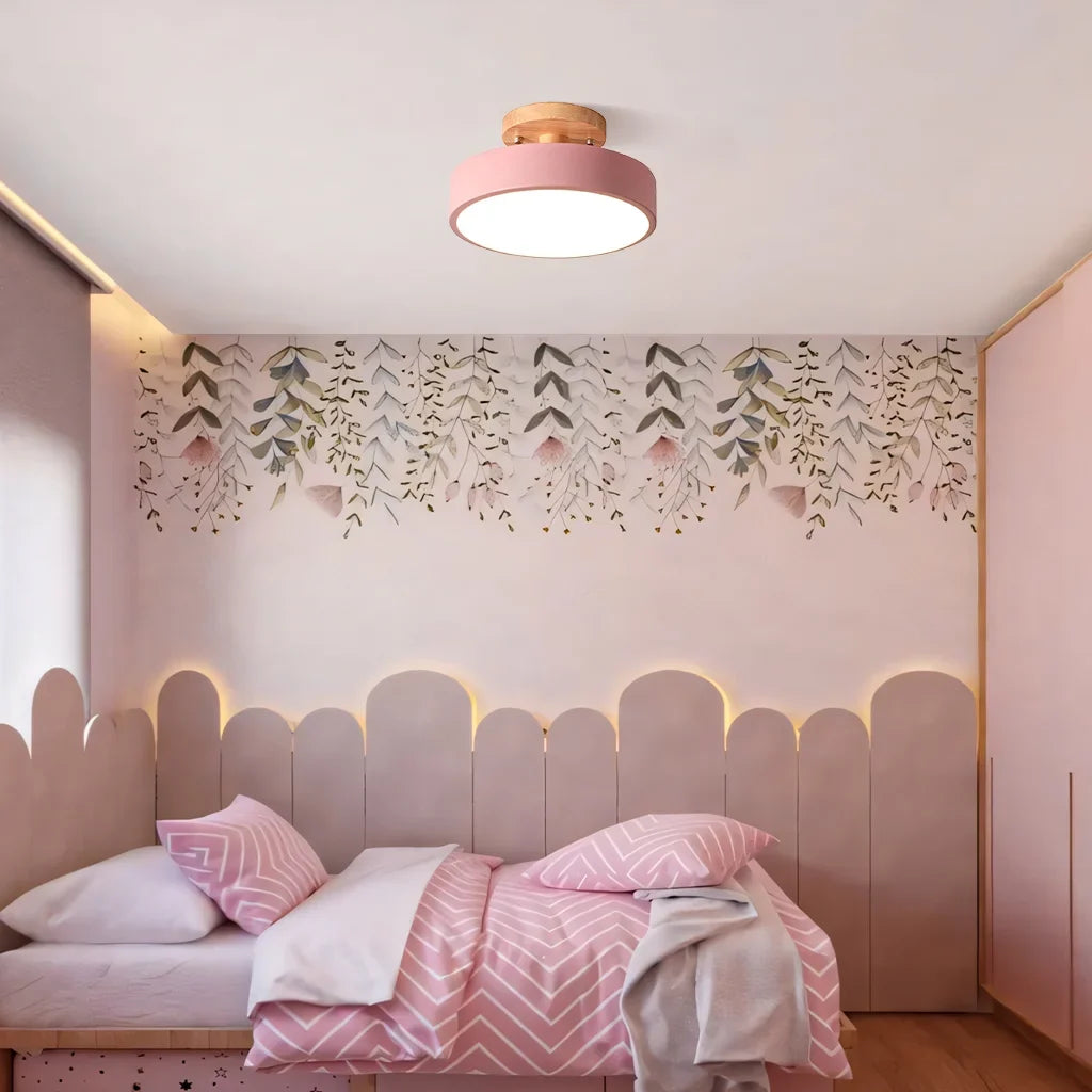 Round wood ceiling light mounted above a bed in a warm minimalist bedroom