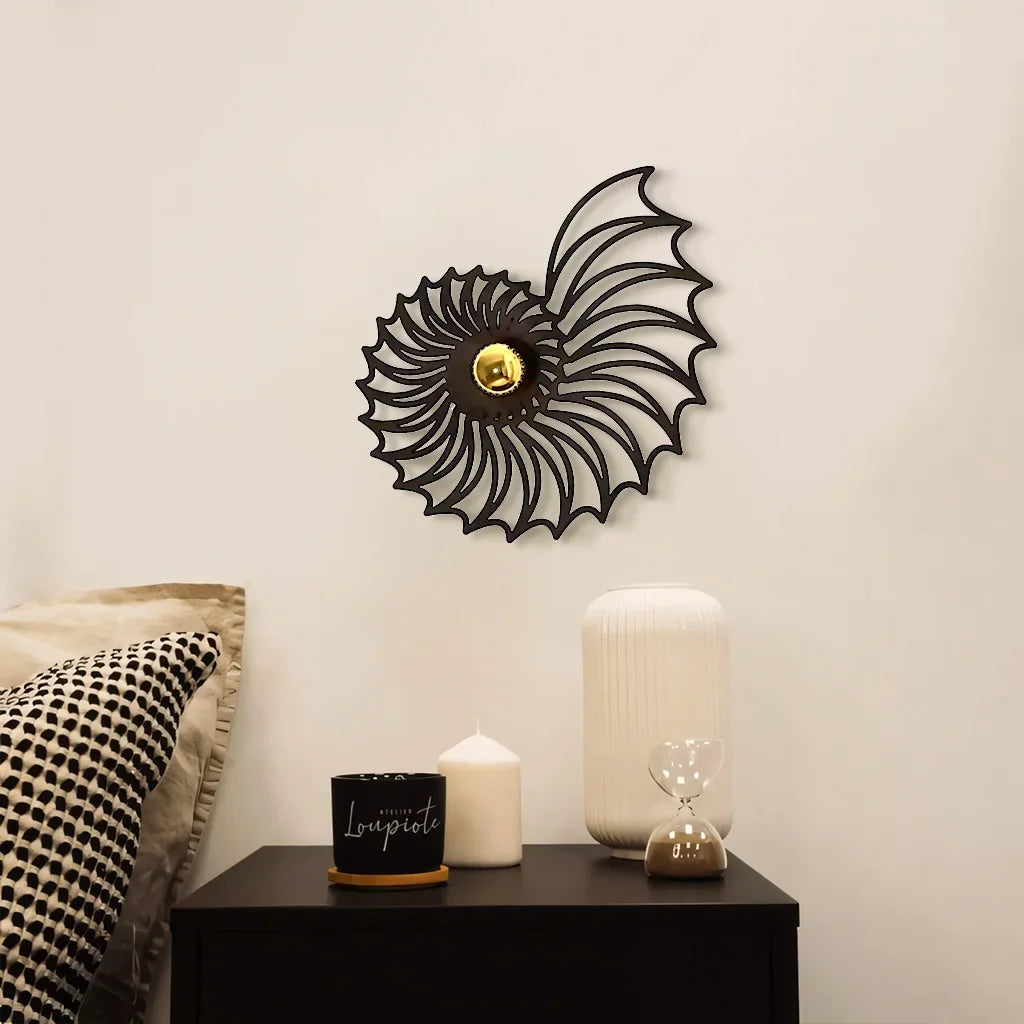 Shell wall light casting shadows in a bedroom