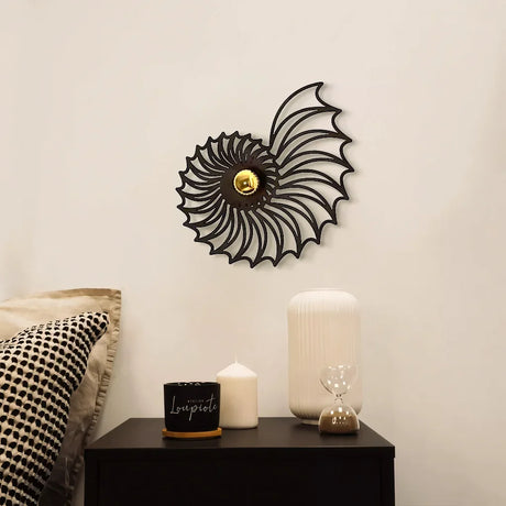 Shell wall light casting shadows in a bedroom