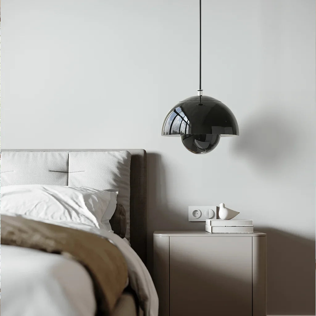 Metal bud pendant light lighting a relaxed bedroom reading corner