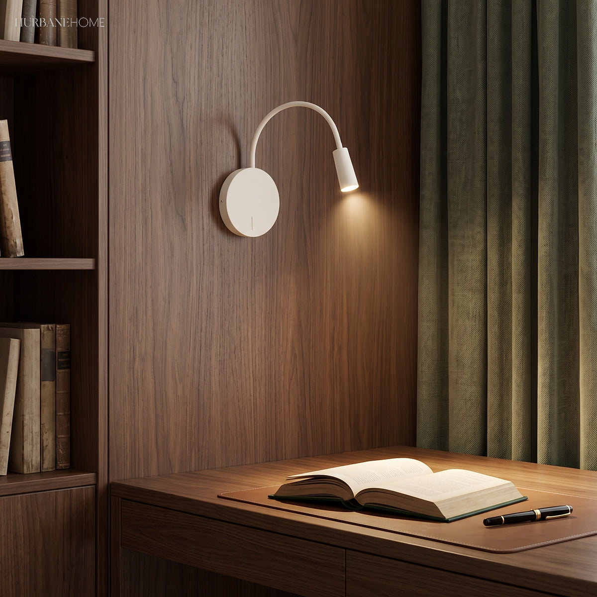 White reading light lit above a timber desk and open book