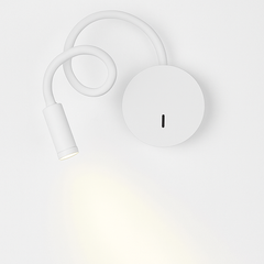 White reading light seen from above with the beam on the wall
