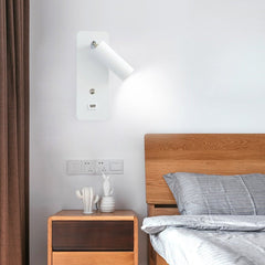 White bedside reading light mounted above a wooden bedside table