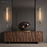Two gold fluted glass sconces flanking a mirror and sideboard