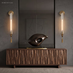 Two gold fluted glass sconces flanking a mirror and sideboard