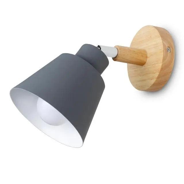 Black bell shade sconce on a wood mount on a white ground