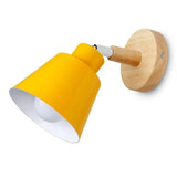 Grey bell shade sconce on a wood mount on a white ground