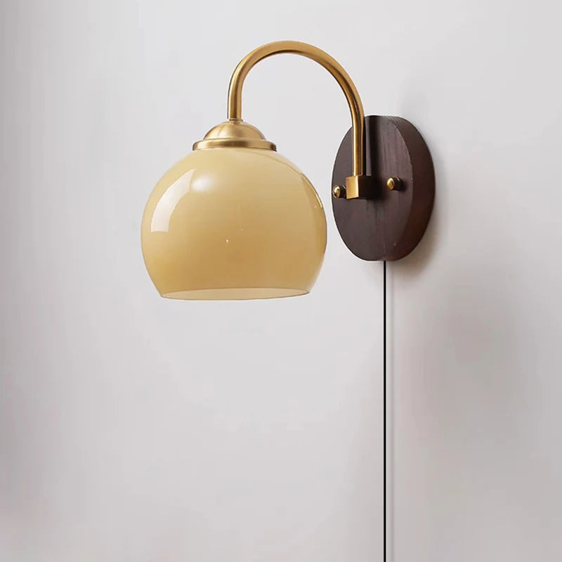 Beige dome glass sconce with pull-chain switch and brass collar