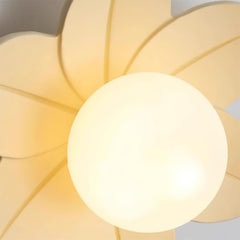 Detail of the beige petals and the lit glass globe seen from directly below
