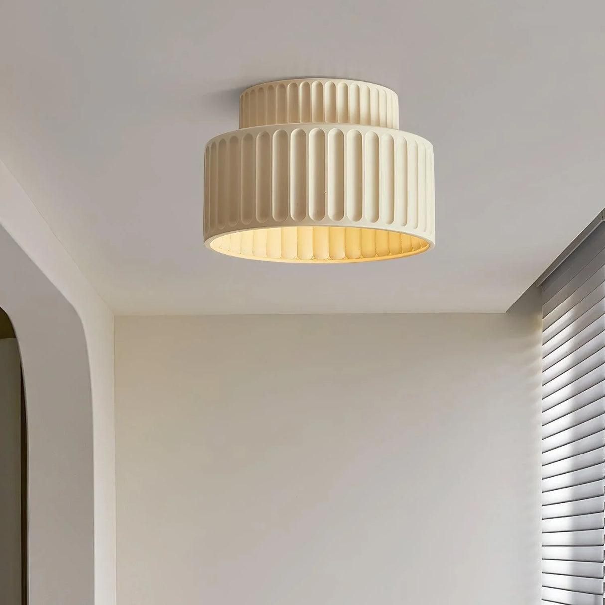 Beige resin ceiling light detail showing the smooth matte finish of the shade
