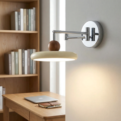 Beige disc shade wall sconce with chrome swing arm close up