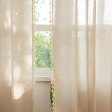 Beige sheer panels hanging in sunlit farmhouse living room 