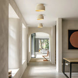 Beige vintage ceiling light shown side on to reveal its stacked fluted profile
