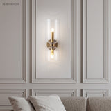 Glass wall sconce on a moulded wall above a sofa in a living room