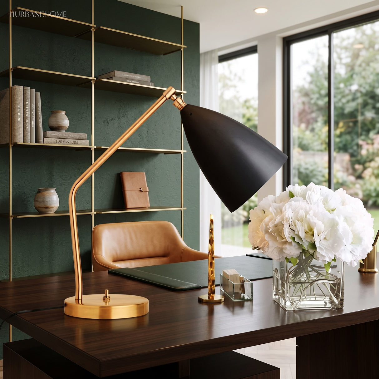 Black and brass table lamp on a study desk beside a leather chair