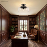 Black glass semi flush mount ceiling light in a wood-panelled study