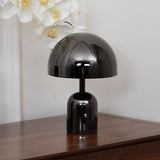 Close view of the black gloss dome lamp on a walnut sideboard