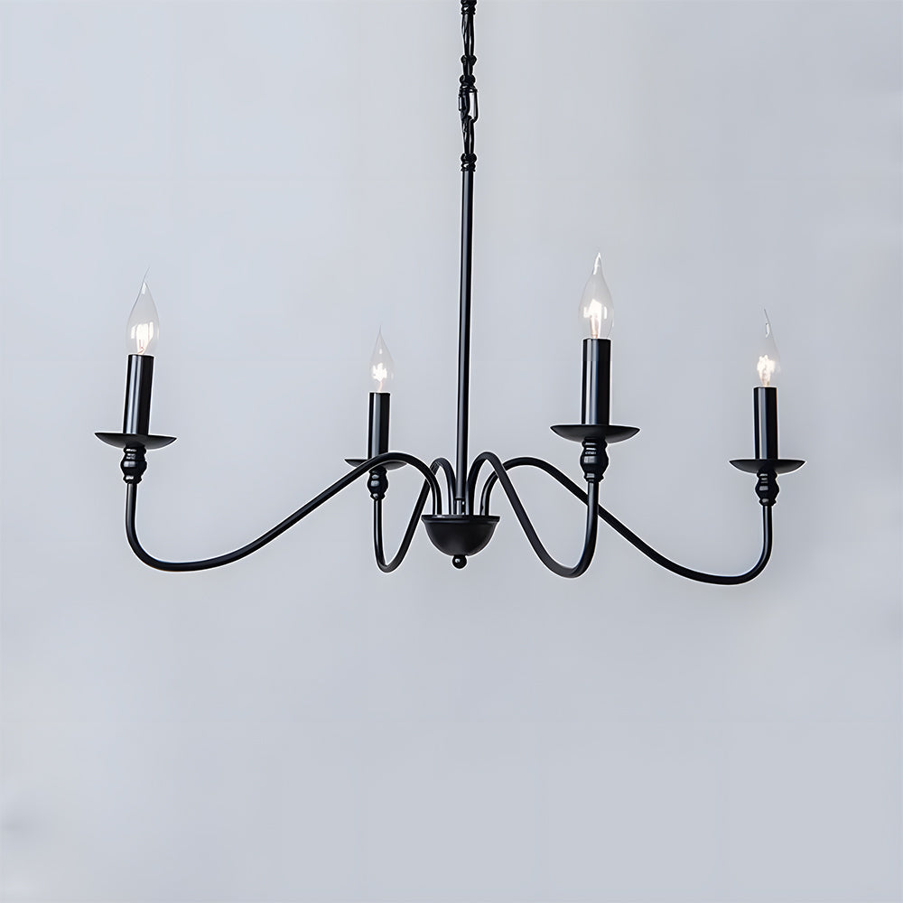 Four light black candle chandelier with curved arms against a pale grey wall