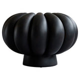 Sculptural pedestal ceramic vase styled with dried botanical stems